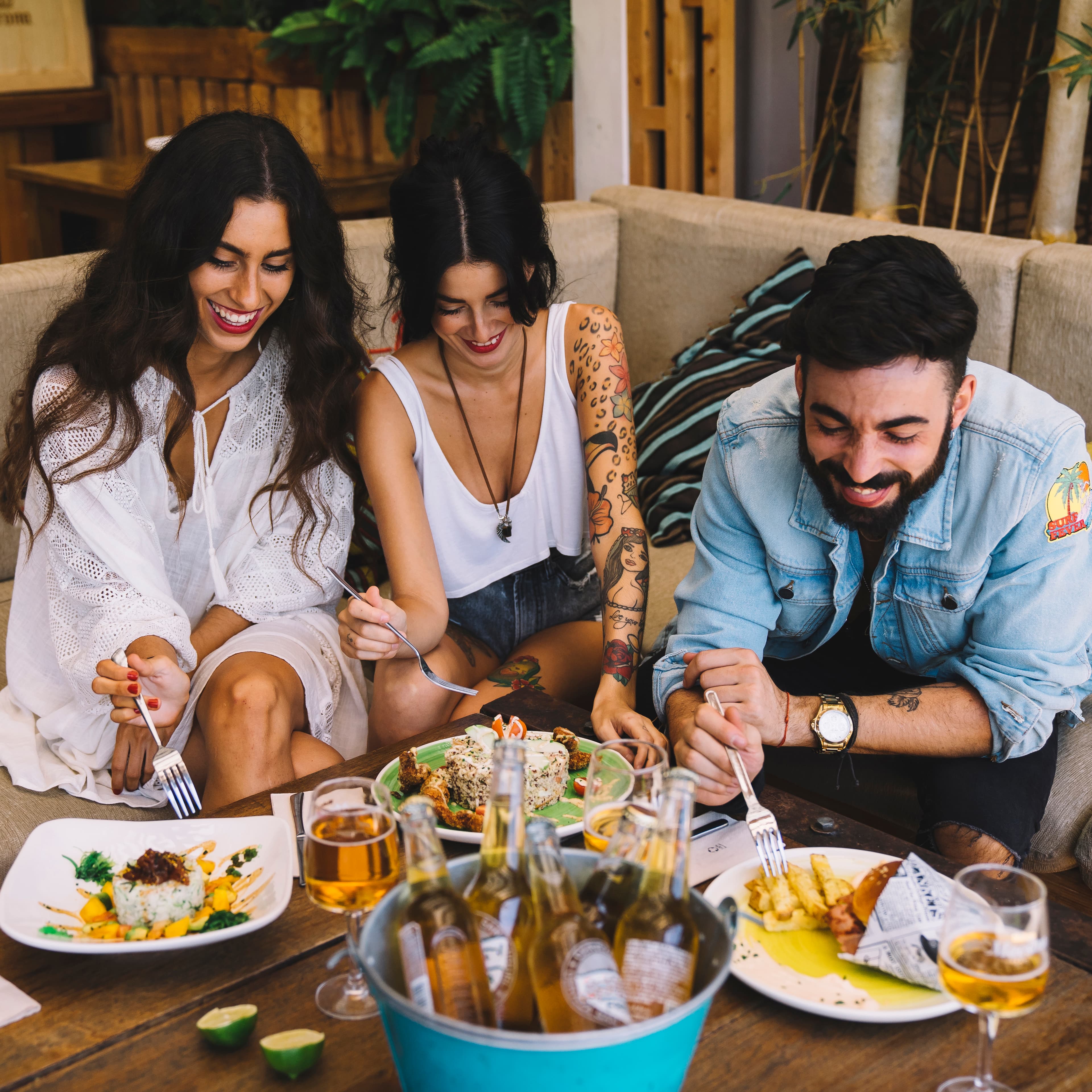 Friends gathered around a table, sharing a meal and laughing together